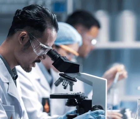 Laboratory specialist examining a sample under the microscope